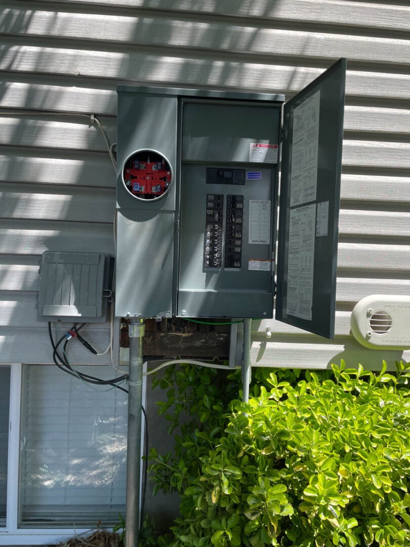 work photos-66 An upgraded grey electric circuit panel box on the outside if a house in Sandy UT