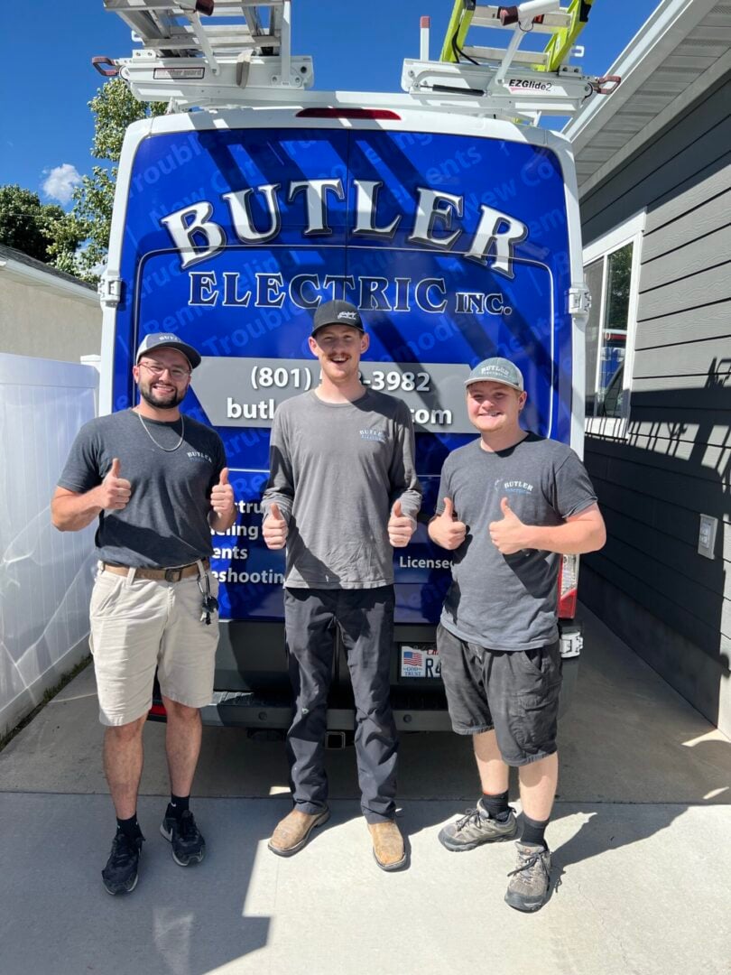 Butler Electric Team Standing Behind the Company Van Smiling