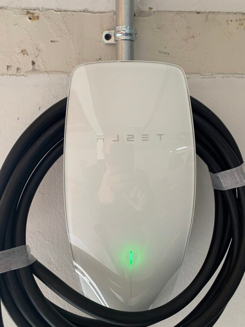 EV Charger A Tesla EV charger installed on a wall in Sandy UT