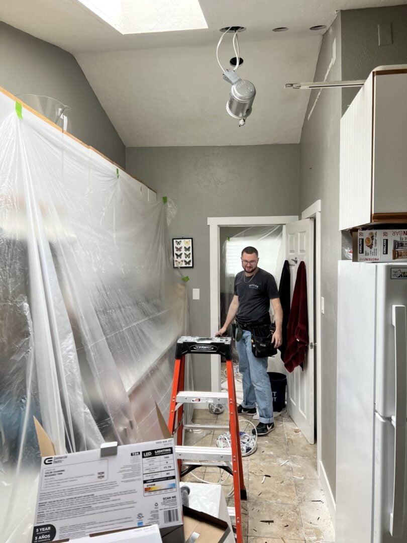 On the Job Basement A man installing can lighting in a basement in Sandy, UT